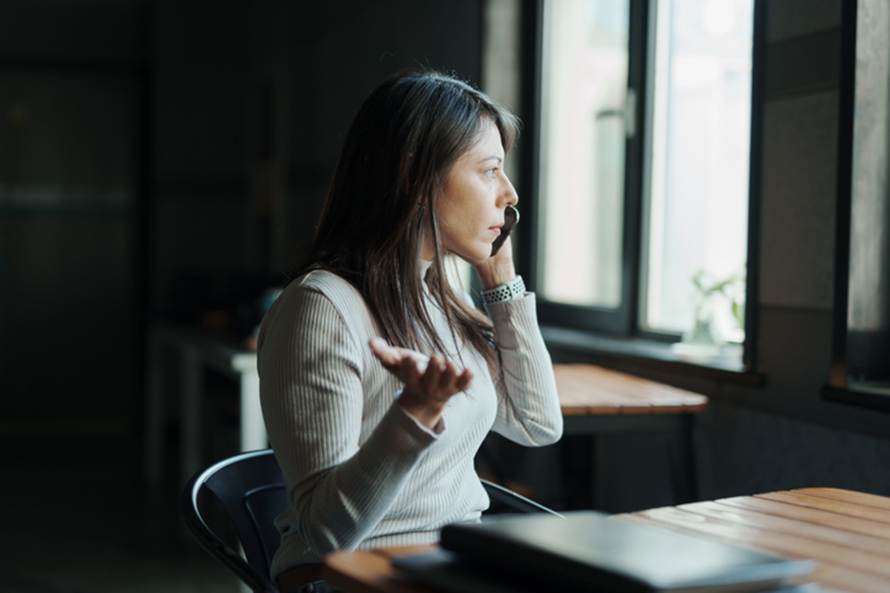 Woman annoyed on phone - Unpaid Wages